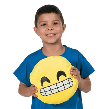 Child holding a yellow emoji pillow with a smiley face expression on a white background